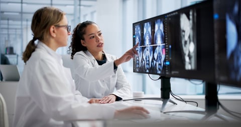 Female radiologist examining spine MRI on computer screen in hospital